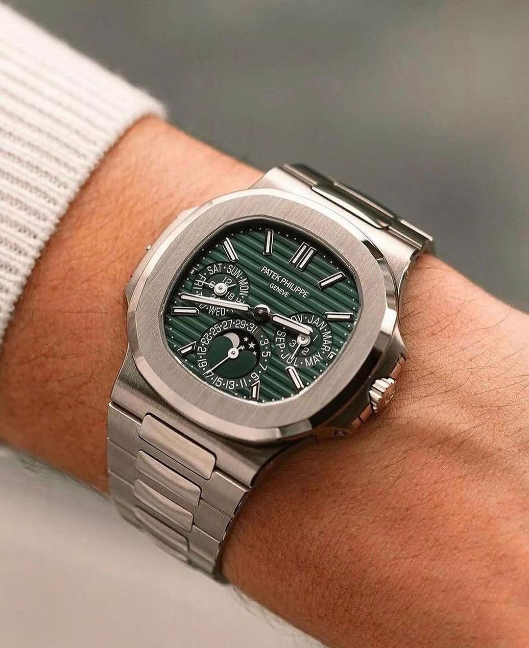 Patek Philippe Nautilus Perpetual Calendar green sunburst dial watch.