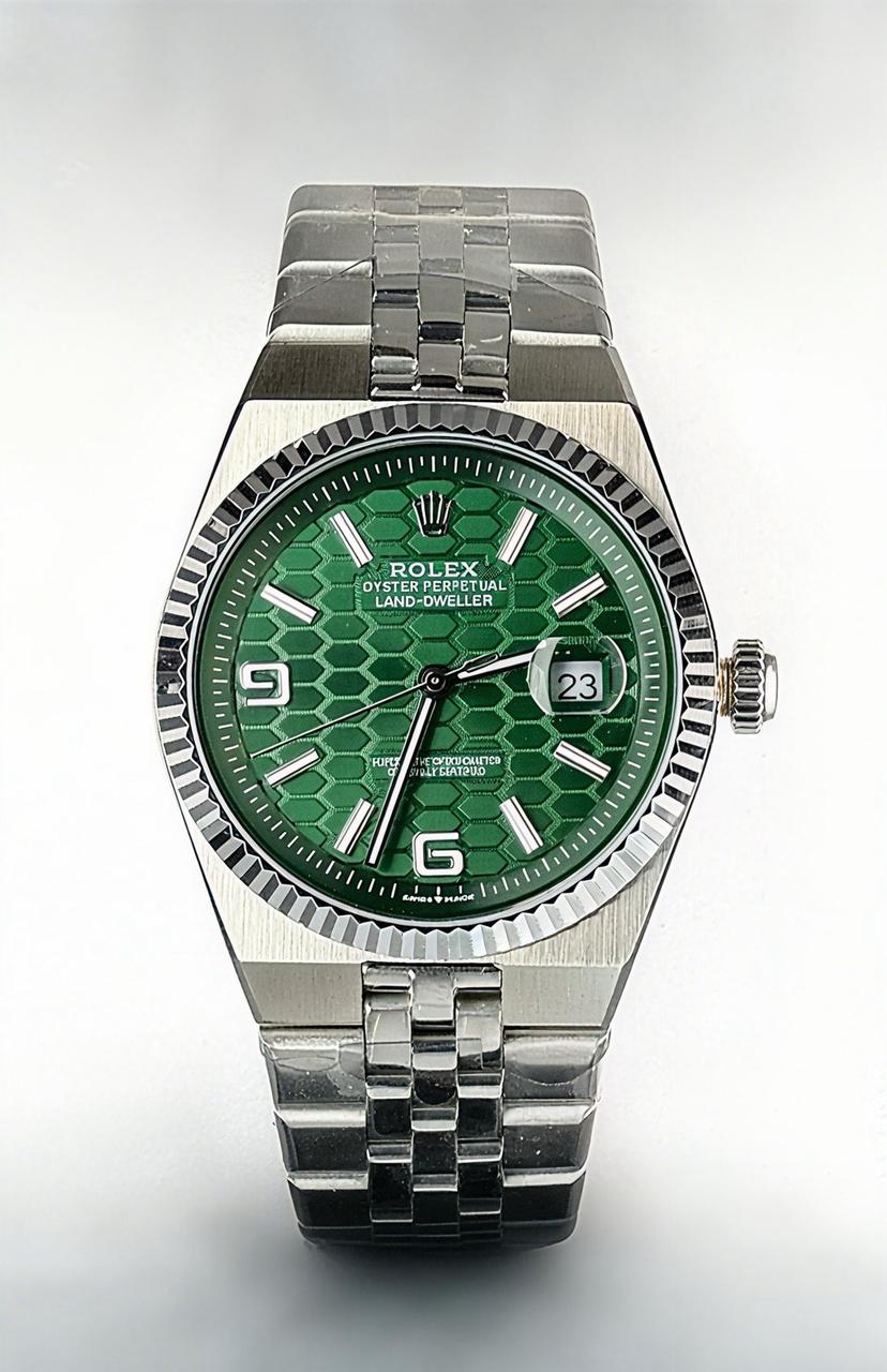 Rolex Oyster Perpetual Land-Dweller with a green dial watch.