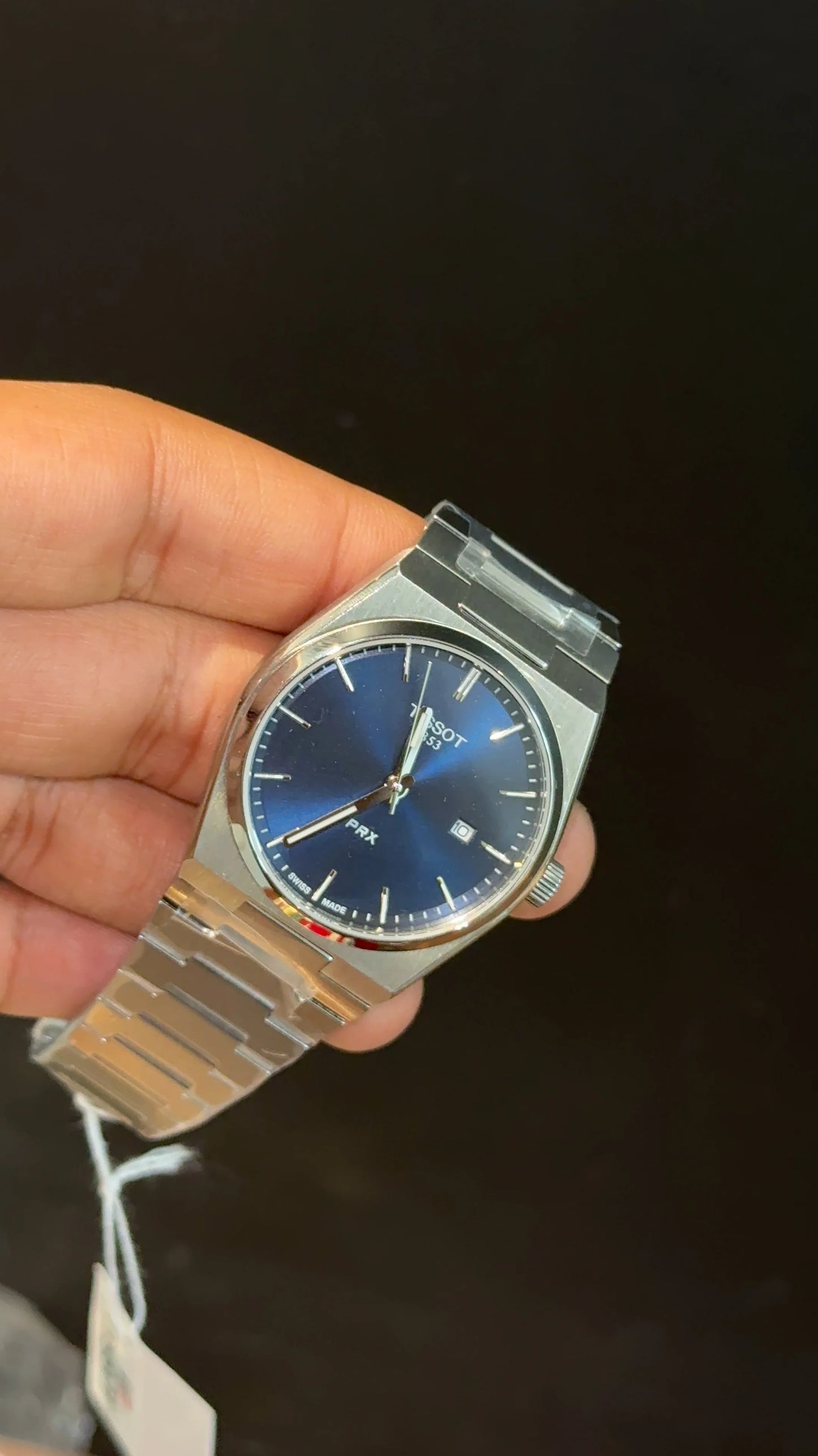 Tissot PRX silver chain with blue dial.