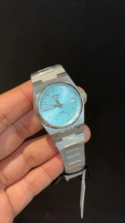 Tissot PRX silver chain with blue texture dial.