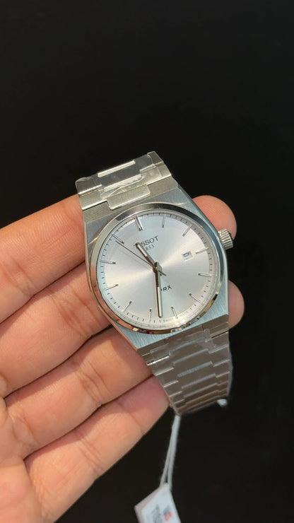 Tissot PRX steel chain with white dial.