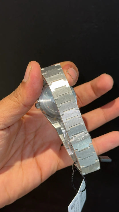 Tissot PRX silver chain with blue texture dial.