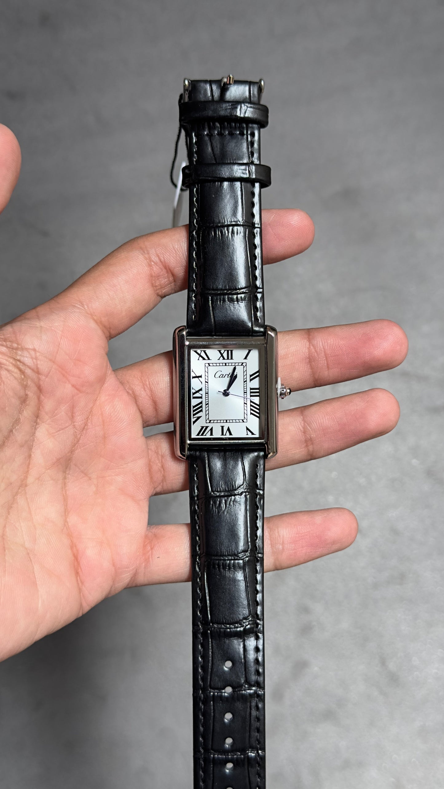 Cartier Tank Louis watch with a white dial and black alligator strap.