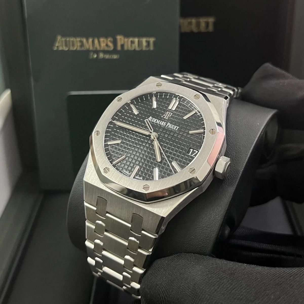 Audemars Piguet Royal Oak black dial watch.