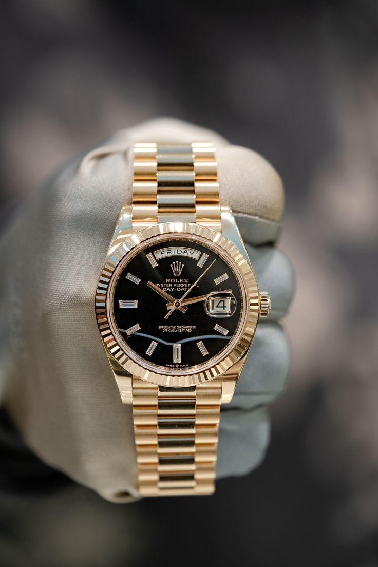 Rolex Day-Date yellow gold with a black dial watch.