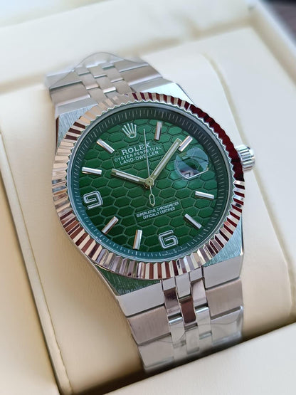 Rolex Oyster Perpetual Land-Dweller with a green dial watch.