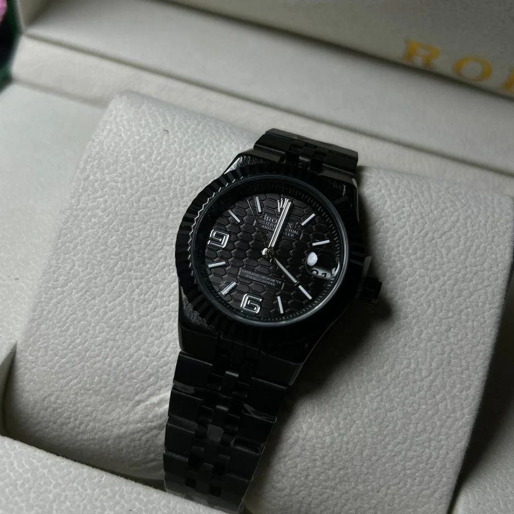 Rolex Oyster Perpetual Land-Dweller watch honeycomb-motif dial and a Jubilee bracelet.