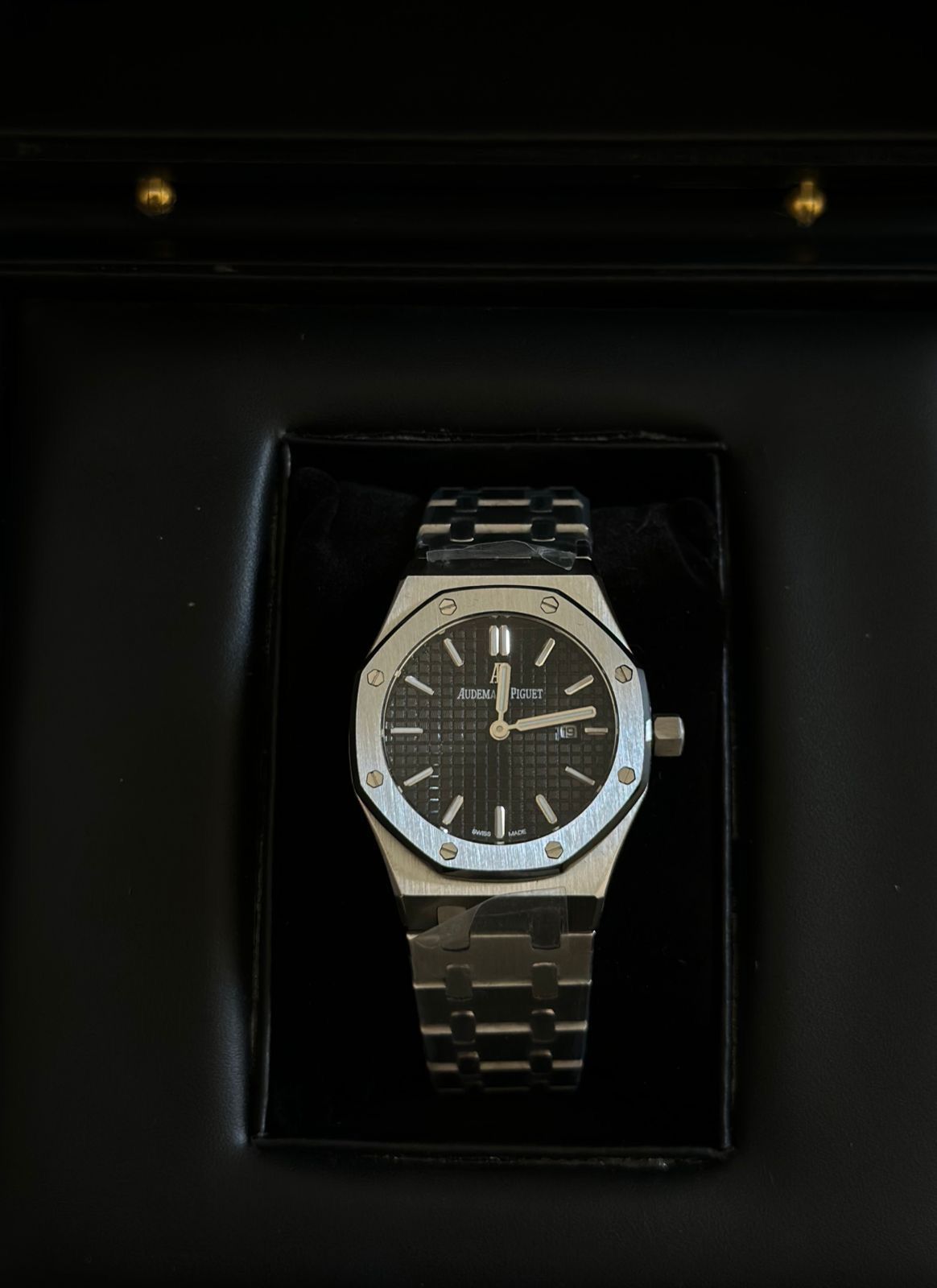 Audemars Piguet Royal Oak black dial watch.