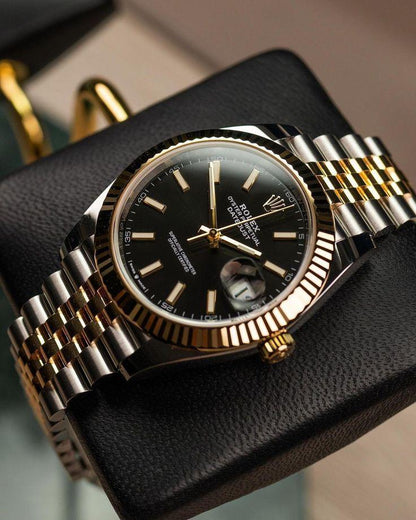 Rolex Day-Date yellow gold with a black dial watch.
