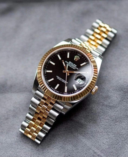Rolex Day-Date yellow gold with a black dial watch.