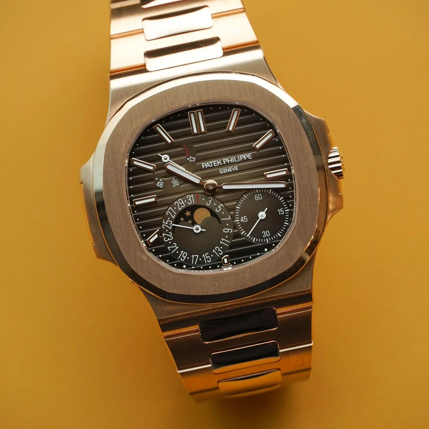 Patek Philippe Nautilus rose gold with a brown sunburst dial watch.